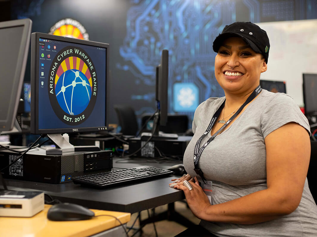 A students its smiling at a computer in the AZCWR