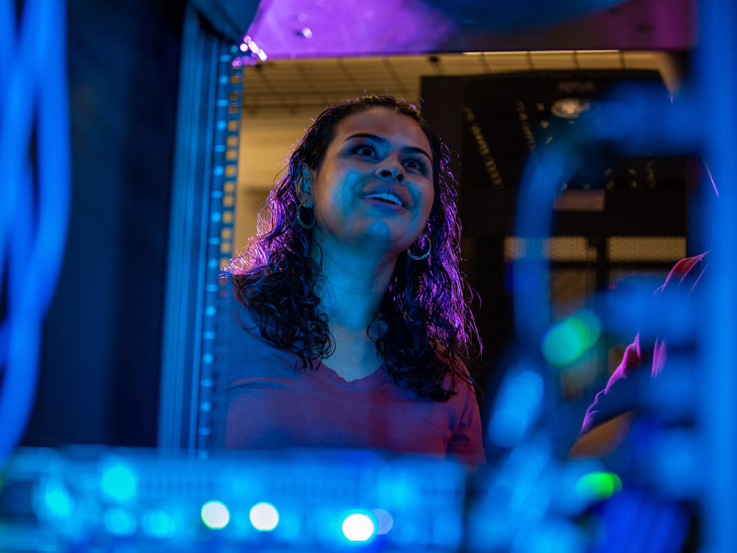 A student inspects a server in the Student Data Center