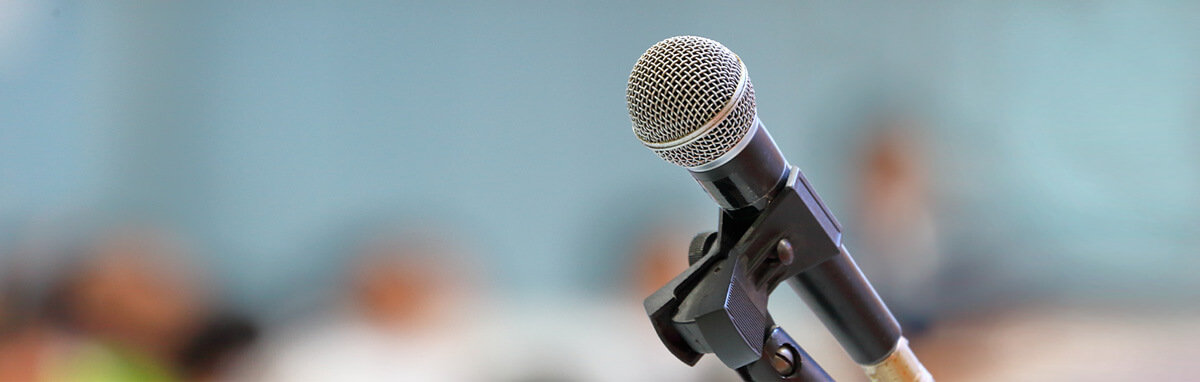 An image of a microphone set up for a speaker in a lecture room