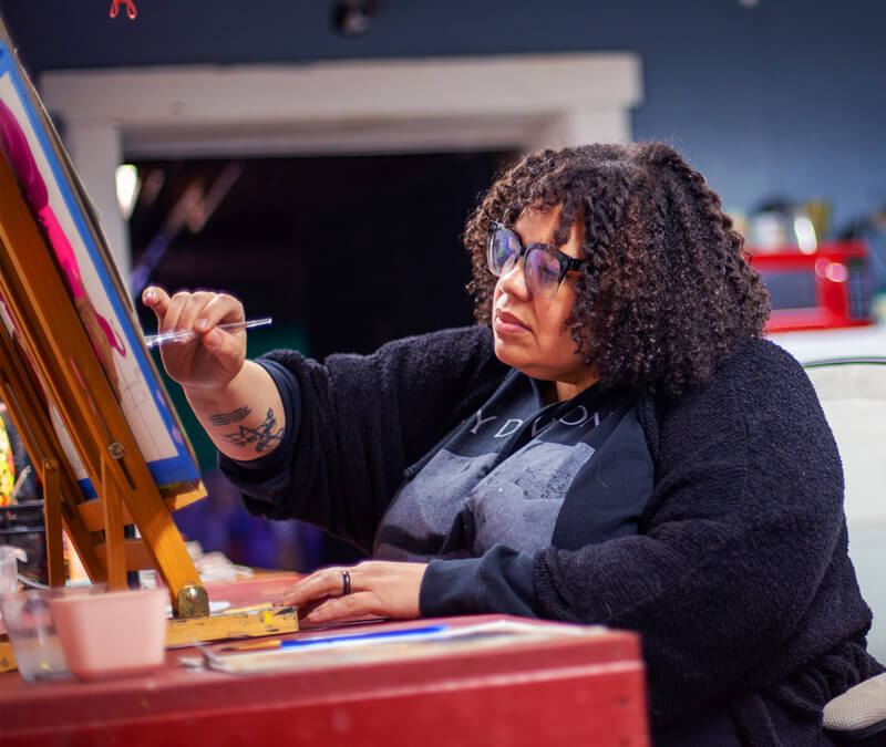 Lizz Denneau works in her studio on a painting