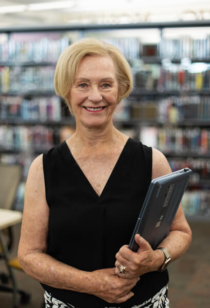 Patricia Owen poses for the camera in PCC's library.