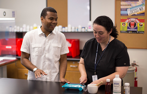 Two people chat during a science class