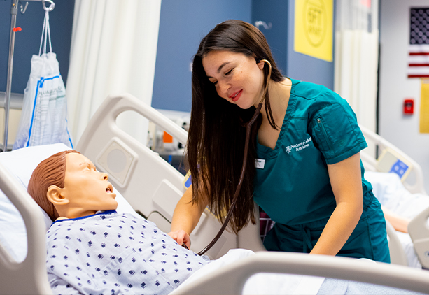 Lizbeth Mora works on a Pima student dummy patient