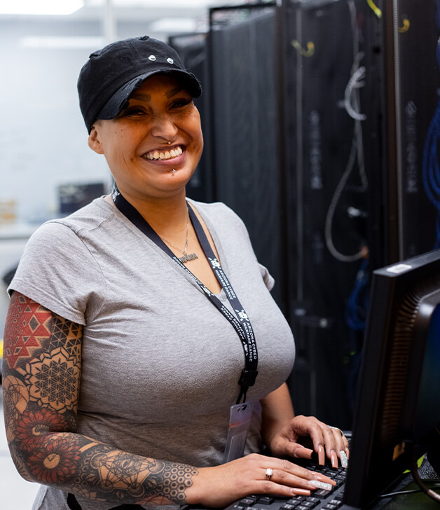 Aurora Sardina Smiles ina server room at Pima East Campus