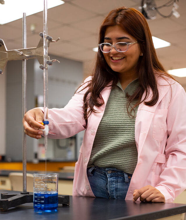 Marian Jimenez works on a titration lab in a lab at Pima's Desert Vista Campus