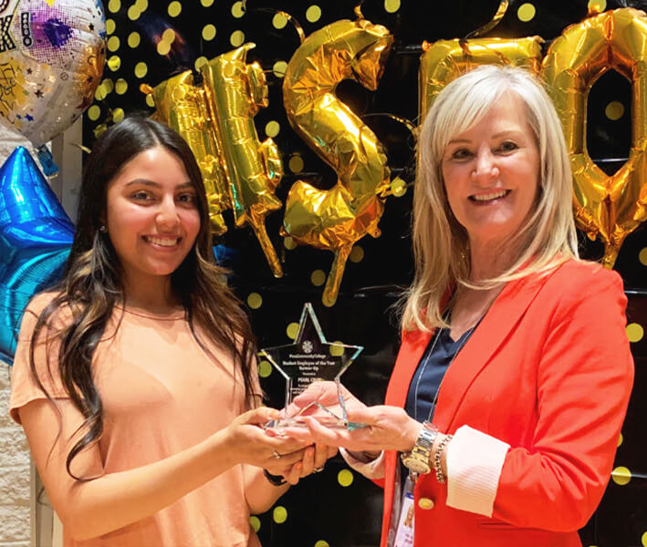 Pearl and Linda Cordier standing with her award