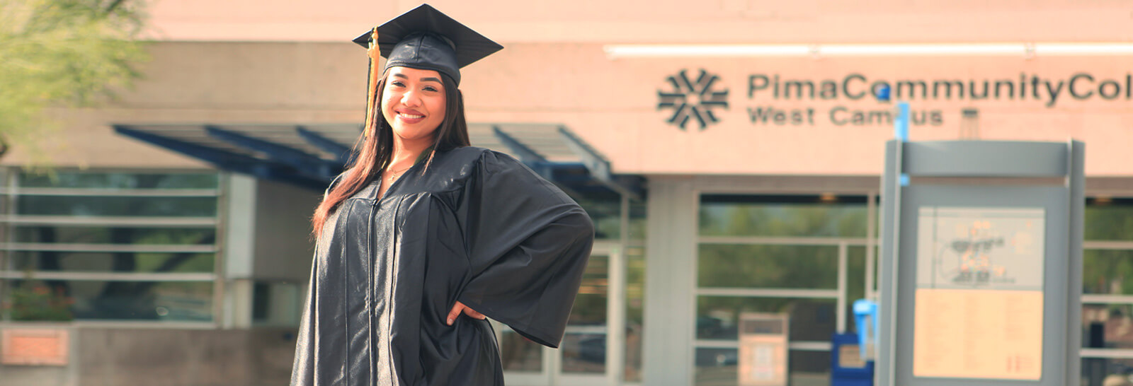 Gabriela Fragozo stands smiling outside of the Student Service Center at Pima's West Campus