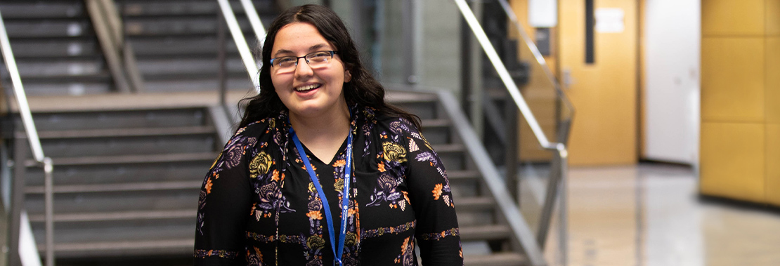 Image of Halianna Piller standing in front of a staircase at West campus