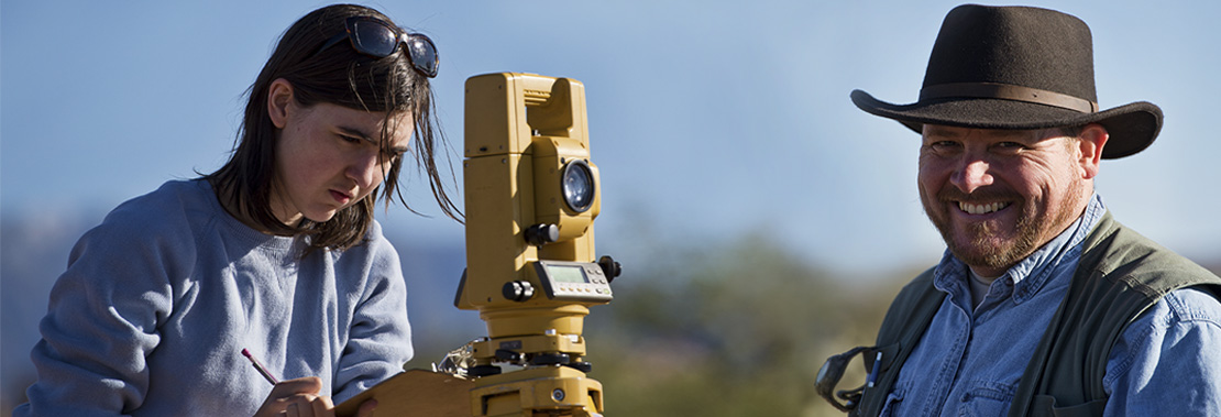 Two students work out in the desert in an effort of preservation and conservation of cultural resources