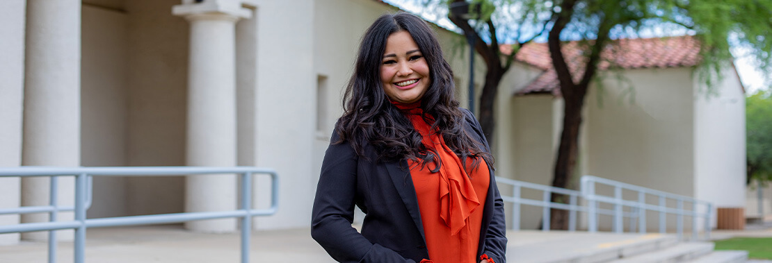 Elizabeth Soto Stands smiling in the courtyard of Downtown Campus