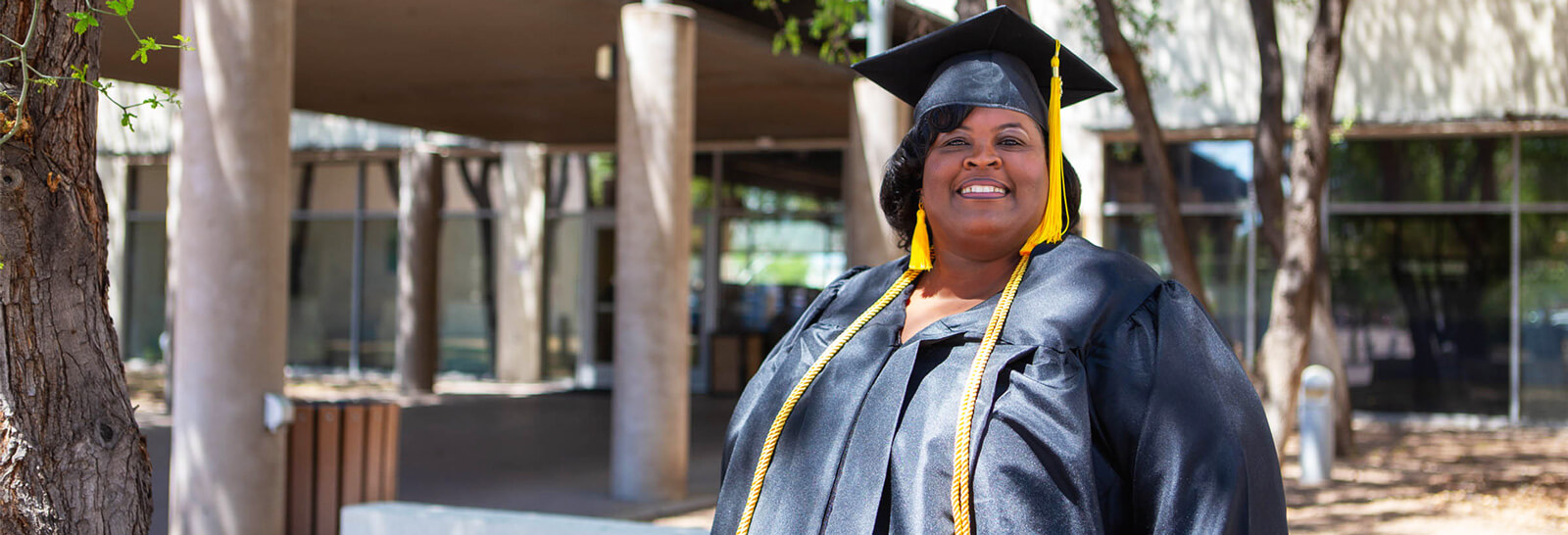 Stacie Williams poses in her graduation cap and gown.