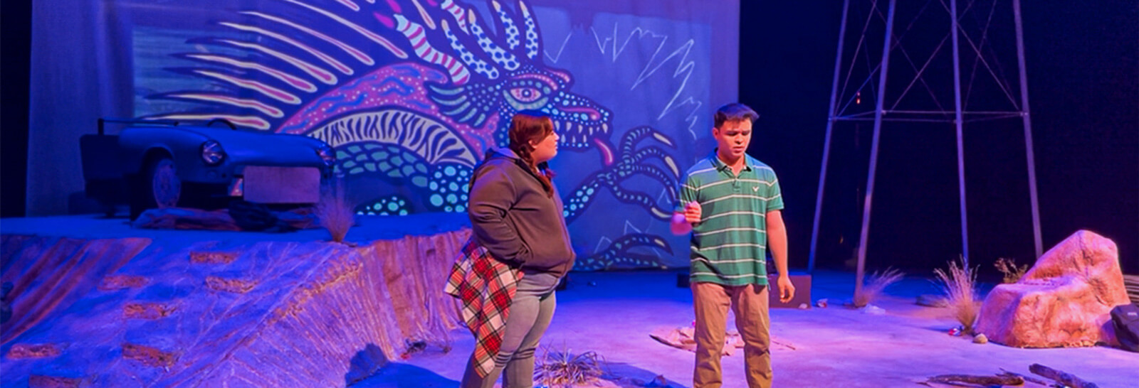 Bridget Wilde’s chupacabra artwork sets the tone behind the performers in “Borderline,” presented by Pima Theater.