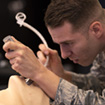 Student in military fatigues in paramedic classroom