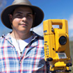 Archaeology student with surveying equipment