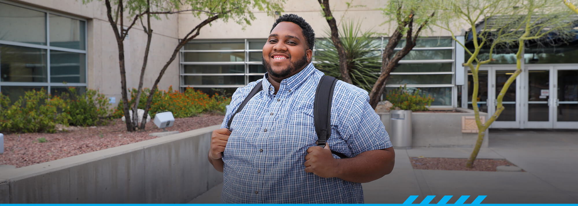 Caleb Bailey poses in front of Pima West Campus main entrance. 