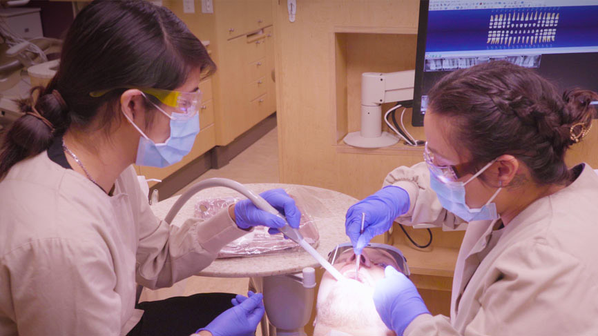 Dental students working on dental patient