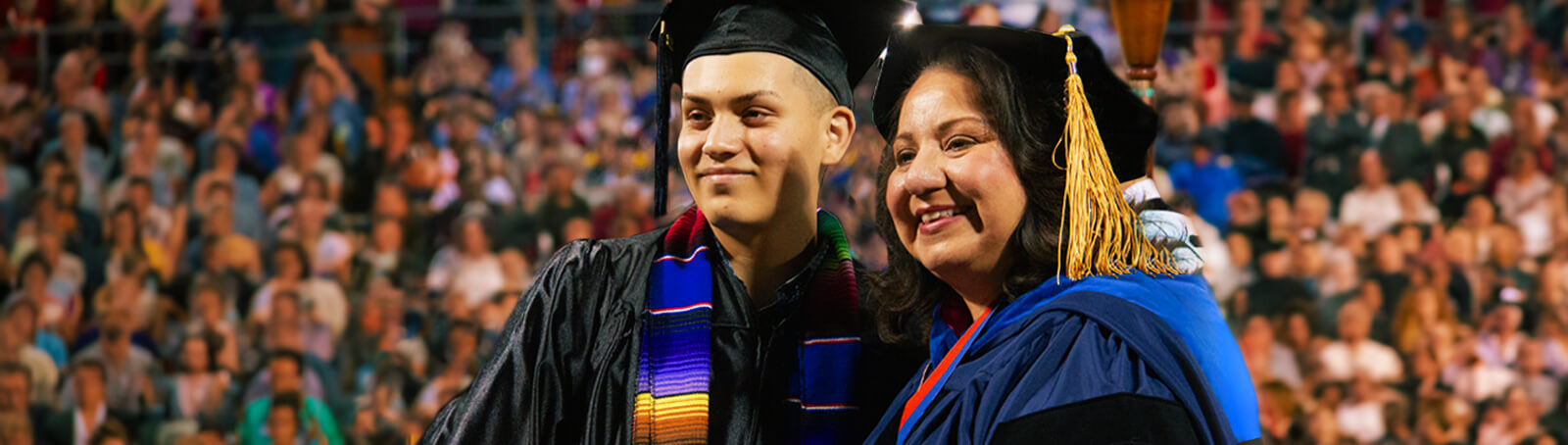 The chancellor takes a photo with a student at graduation