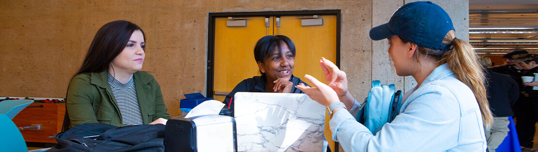 Students speak in ASL in a student lounge at a Pima campus