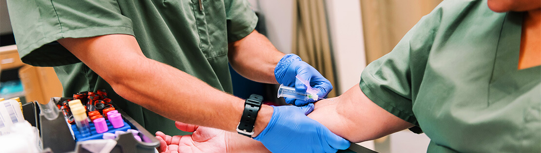 Two Pima phlebotomy students set up to practice in a Pima lab