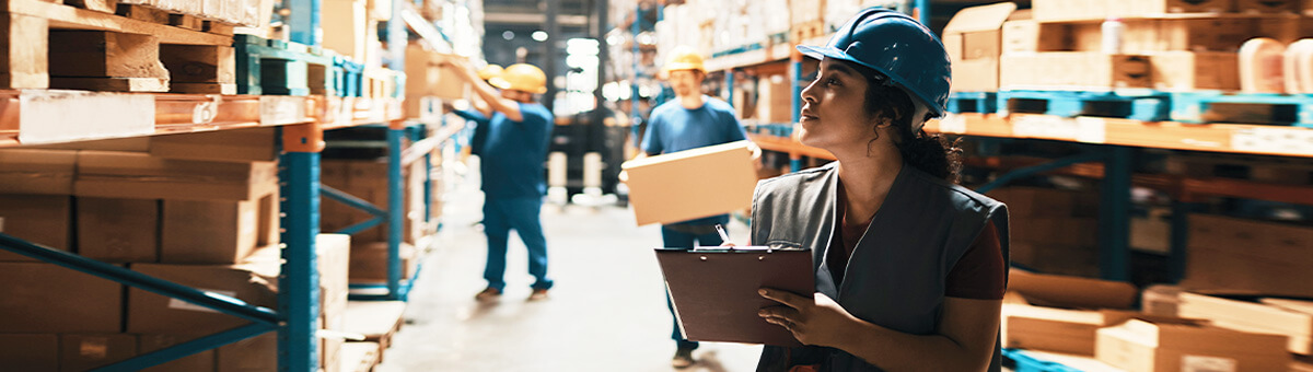 A female businesswoman review supply logs in a warehouse