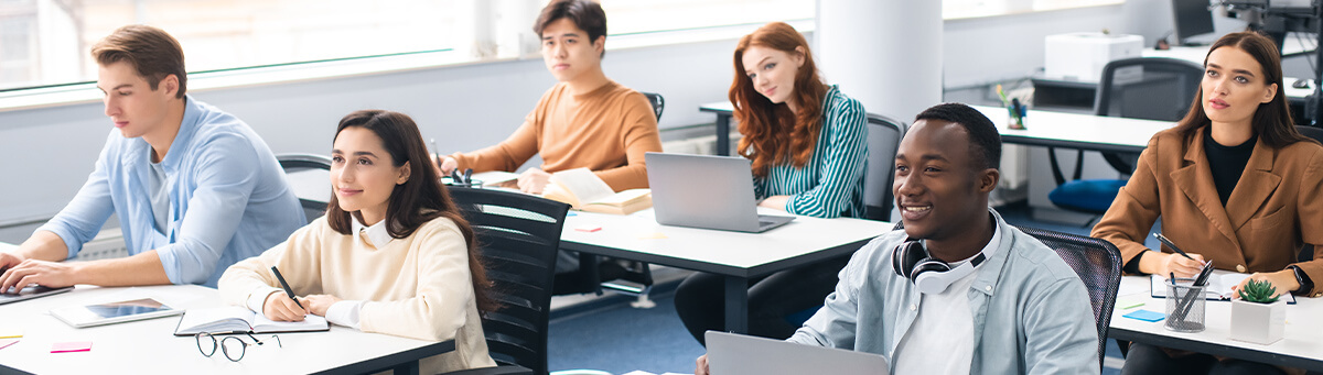 A group of older students sit in a classroom