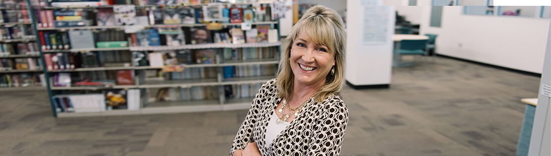 A senior student poses in a Pima Library