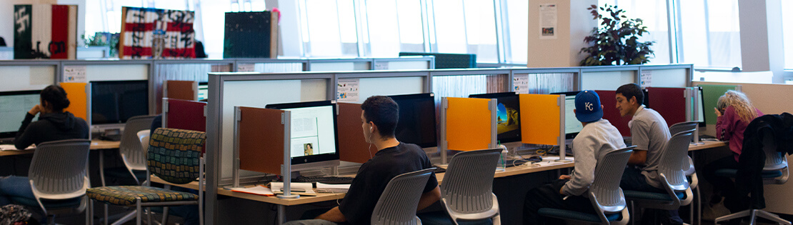 Students work in computer commons in a pima library