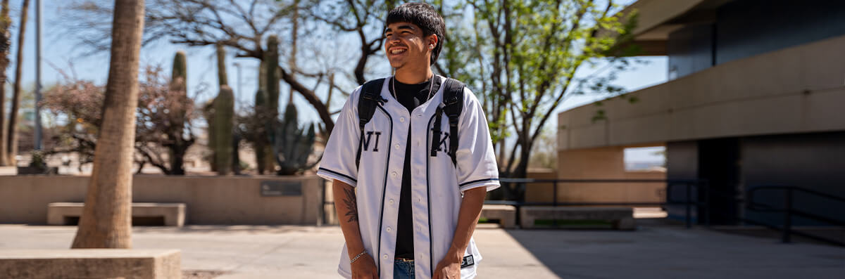 A student smiles while posing on Pima's west campus.