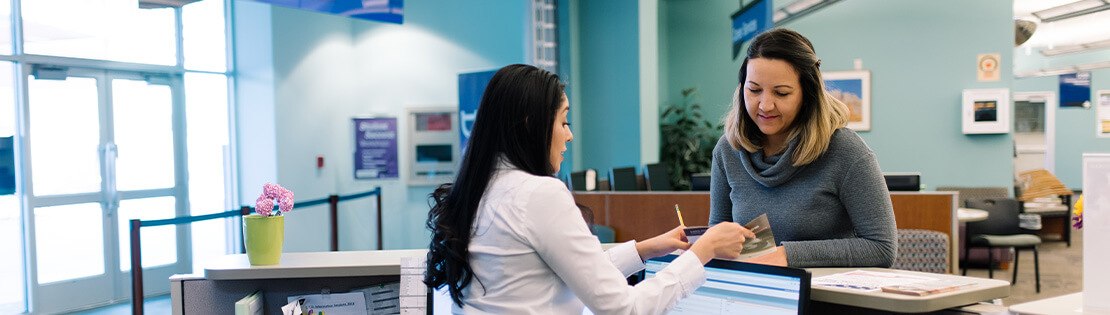 A woman speaks with a student services advisor.