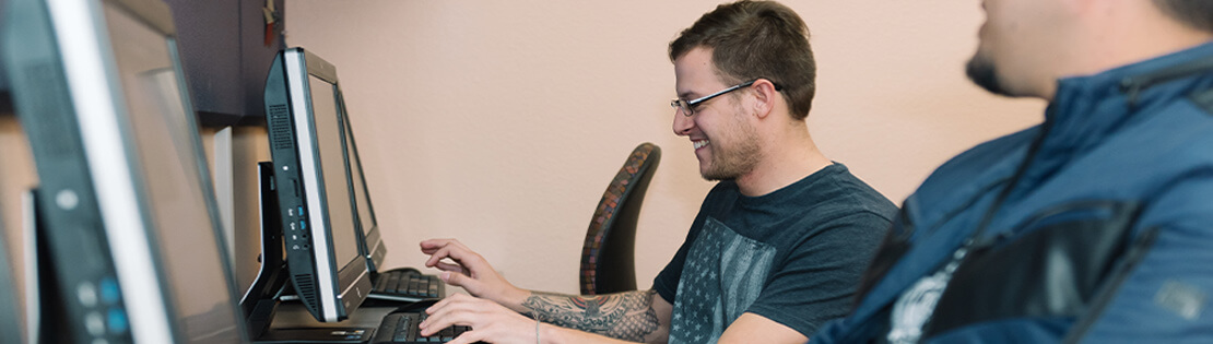 A student in a Pima Student Center works on a computer