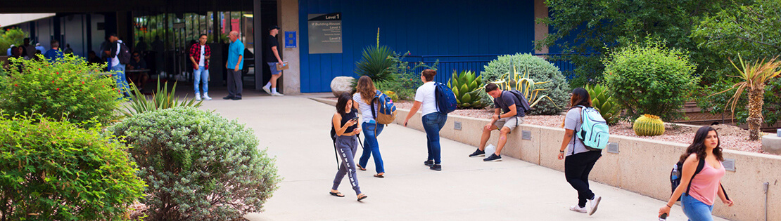 Students walk between the breezeways at Pima's West Campus