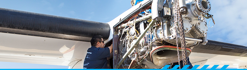 2 aviation program students working on airplane