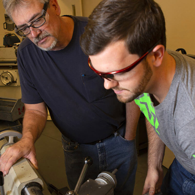 Brian works on a machine with an instructor