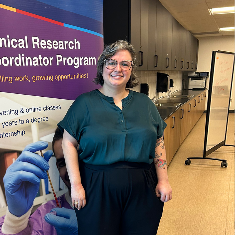 Marissa Stands smiling in a classroom